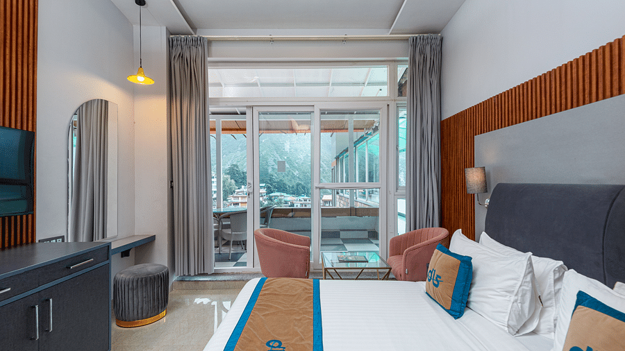 Spring Duplex Room at DLS Spring  Valley resort Dharamshala featuring a king bed table, chairs and a  balcony